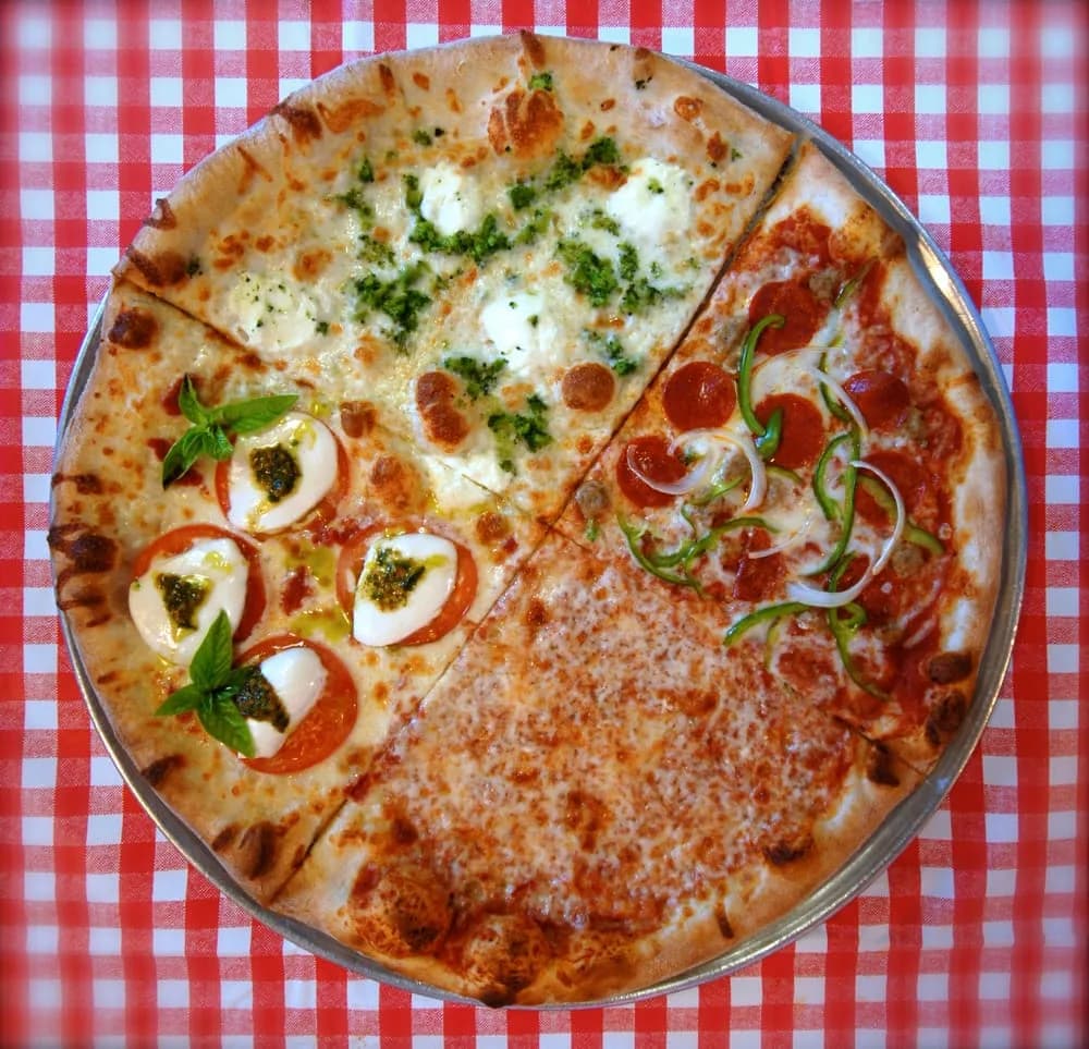 Four pizzas arranged on a red checkered tablecloth